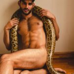 Nude Indian Hunk Posing with a Giant Python