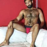 Hairy naked bear showing off his furry body