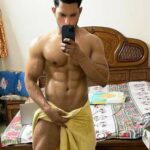 Muscular naked stud posing in just a towel