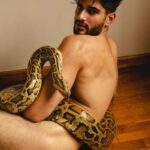 Indian male model posing naked holding a snake