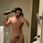 Muscled nude hunk shows off big dick in the mirror