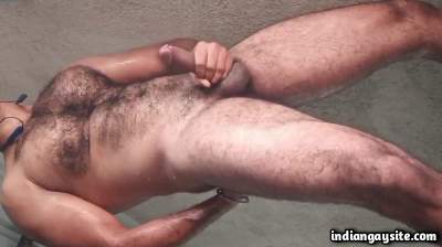 Muscled hairy man jerking his big dick wildly for fans