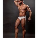 Gay underwear model flexing muscles in hot nudes