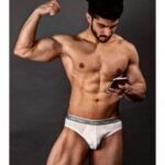 Gay underwear model flexing muscles in hot nudes