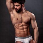 Gay underwear model flexing muscles in hot nudes