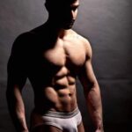 Gay underwear model flexing muscles in hot nudes